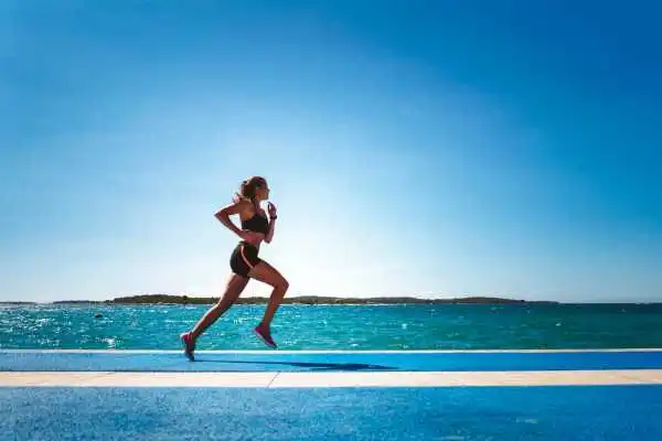 Woman running showing strong leg muscle Barnet